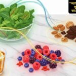 অ্যান্টিঅক্সিডেন্টে ভরপুর সুস্বাদু খাবারের একটি রঙিন ছবি যেখানে বেরি, শাকসবজি, বাদাম ও হার্বাল চা সুন্দরভাবে সাজানো রয়েছে।